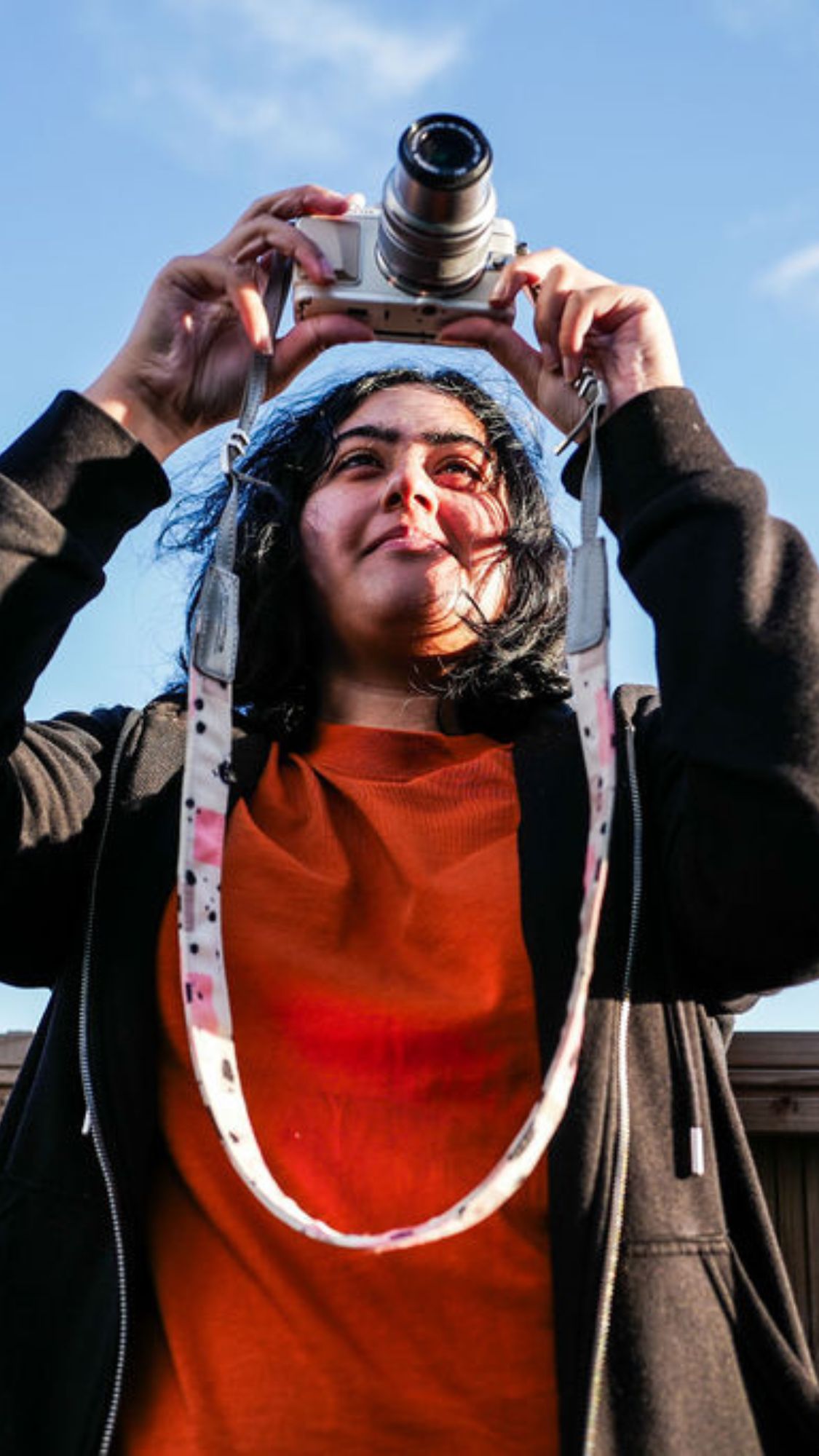 Young woman holding a camera