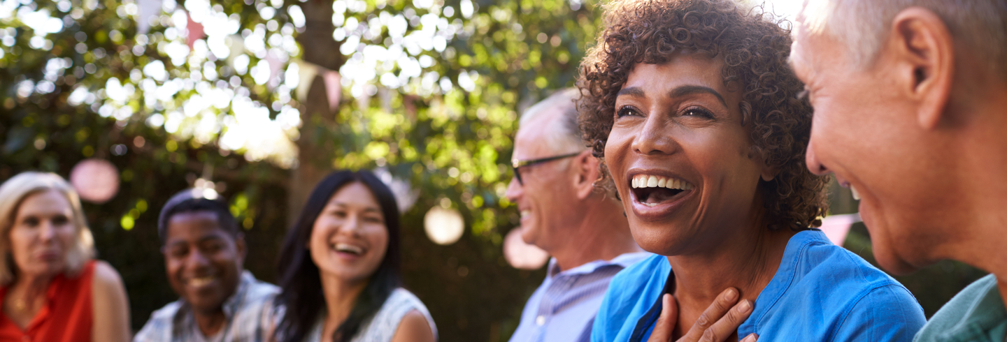 diverse group of people laughing together on a summers day