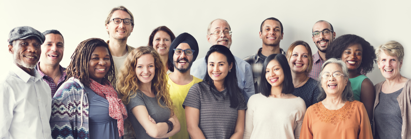 Diverse group of people smiling and dressed colourfully