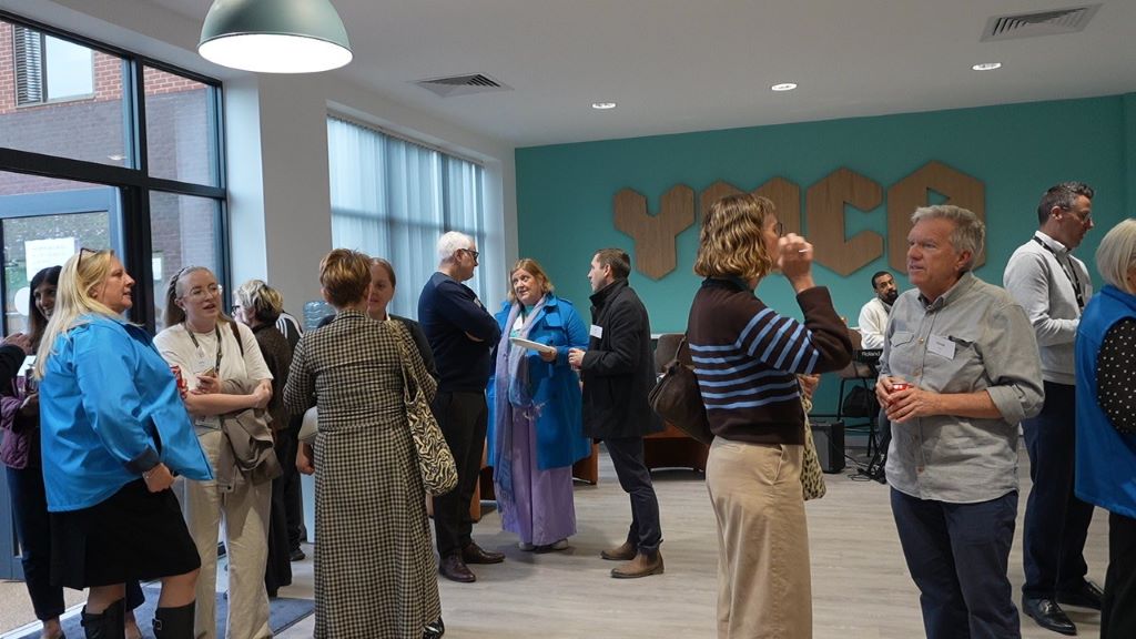 Group of people talking in small groups in YMCA