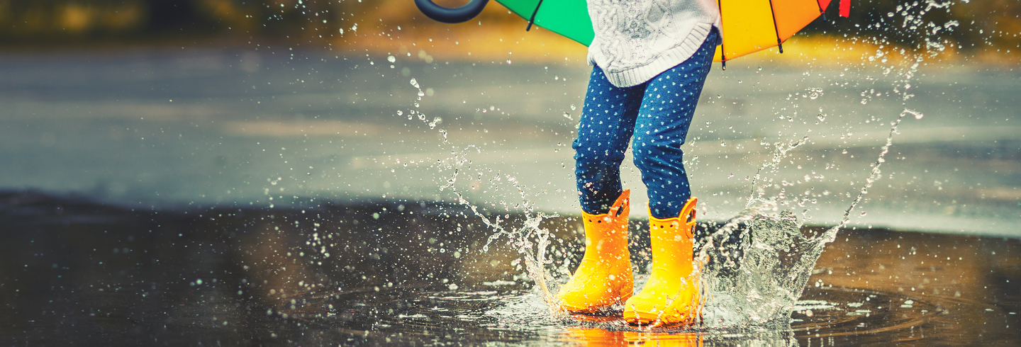 Child jumping in a puddle