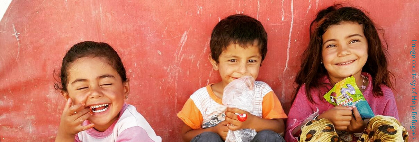 Children with sweets credited to Help Refugees 1440X490